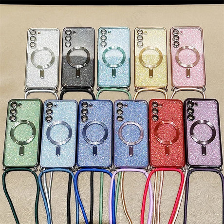 Collection of glittery phone cases with ring holders and attached lanyards in various colors.