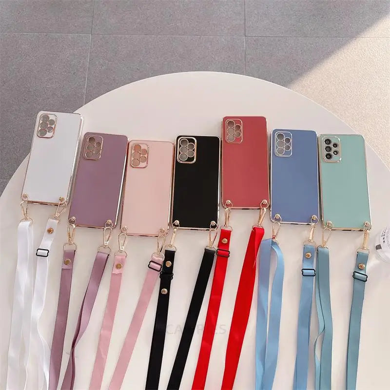 Collection of smartphone cases in various colors with attached lanyards.