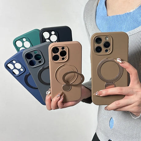 A collection of solid-colored iPhone cases with integrated magnetic rings and kickstands.