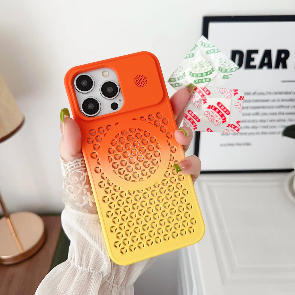 Colorful gradient iPhone case with a perforated pattern transitioning from orange to yellow.