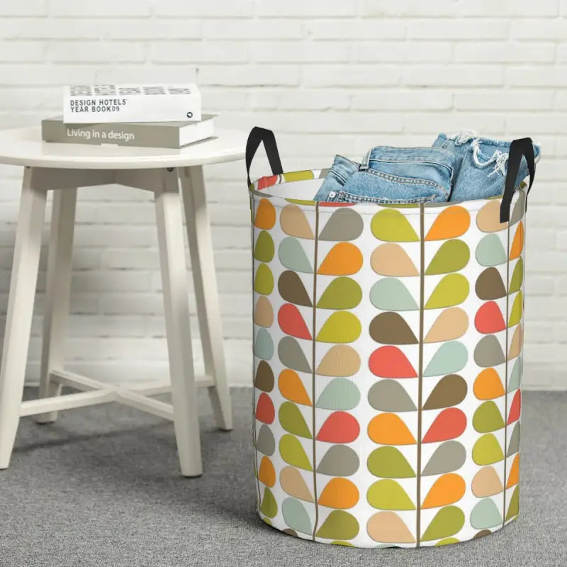a colorful leaf pattern laundry basket with a white background