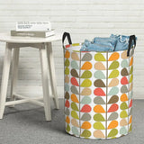 a colorful leaf pattern laundry basket with a white background