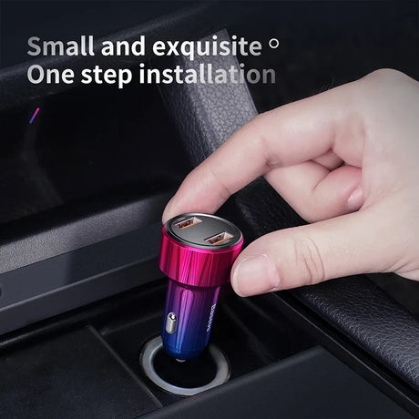 Colorful metallic USB car charger being inserted into a vehicle’s power outlet.