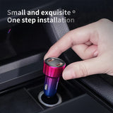 Colorful metallic USB car charger being inserted into a vehicle’s power outlet.