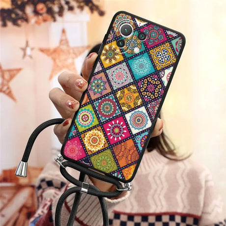 a woman holding a phone case with colorful patterns