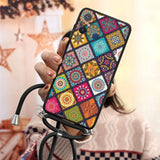 a woman holding a phone case with colorful patching