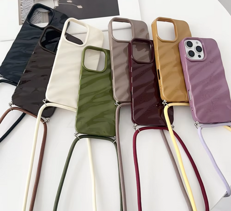 Colorful phone cases with attached straps.
