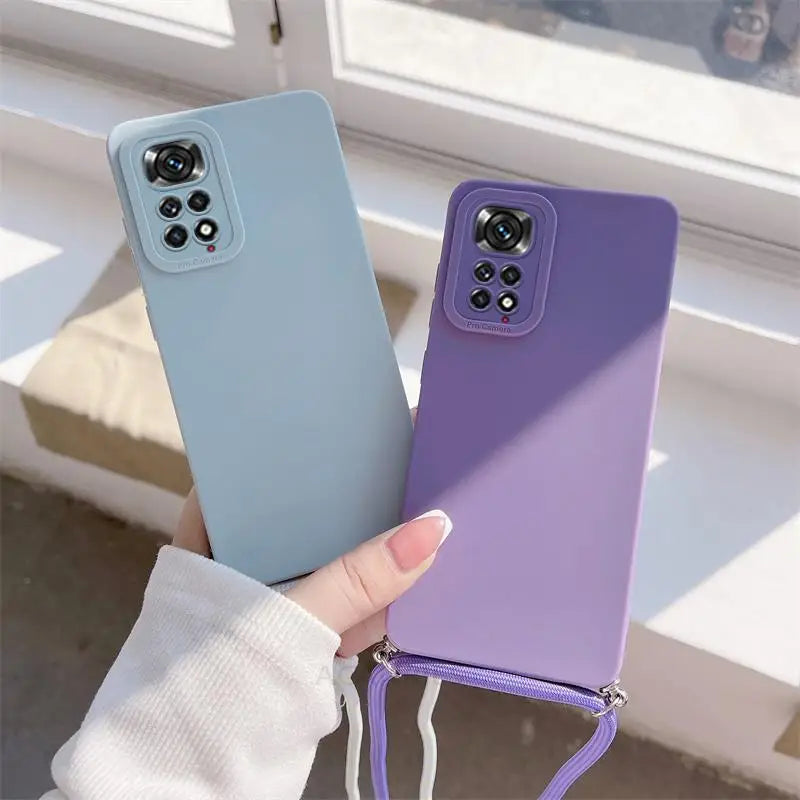 a woman holding a purple and blue phone case