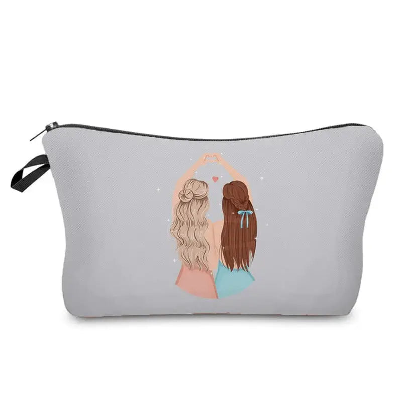 a grey makeup bag with a woman’s face and a pink heart on the side