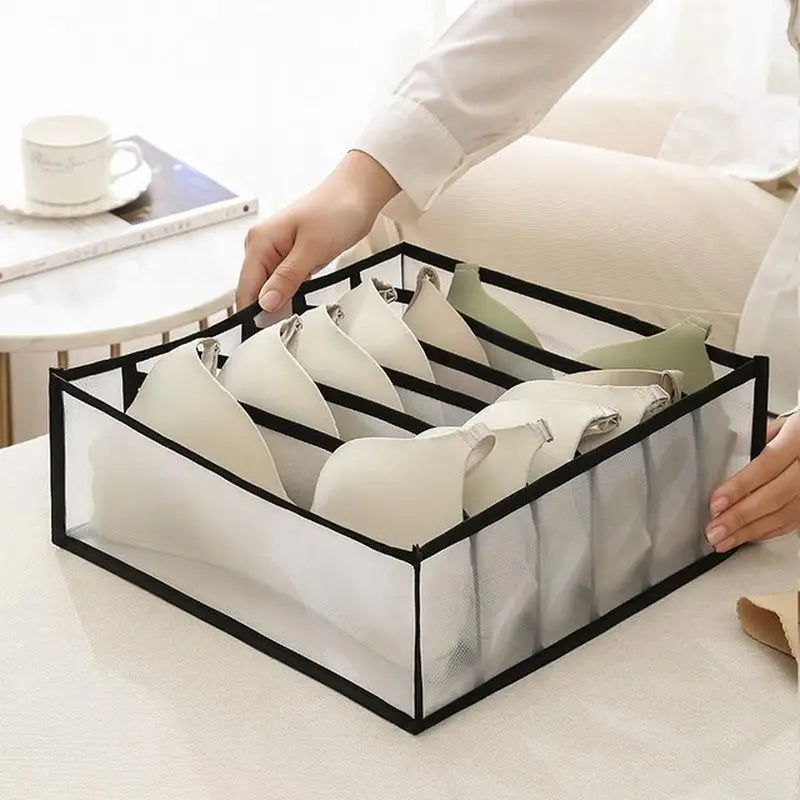 a woman is putting a pair of shoes in a box