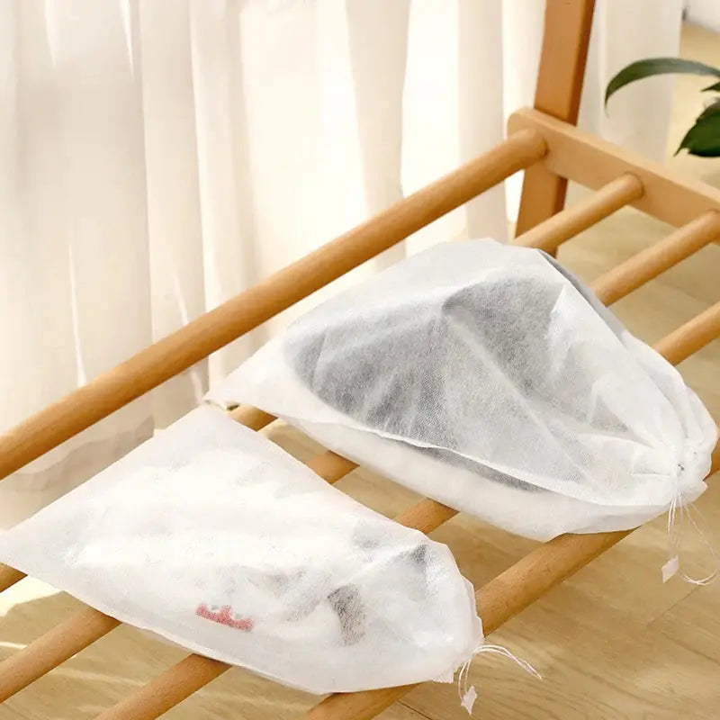 two bags of white tissue on a wooden table
