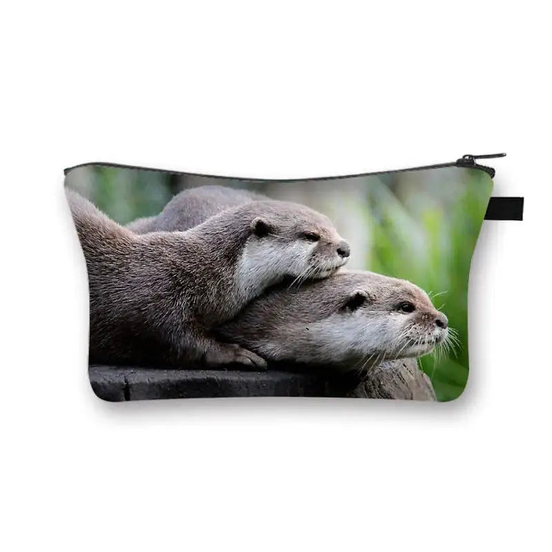 a pair of otters on a black background cosmetic bag