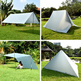 a white tent with a black and white tent on the grass