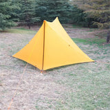 a yellow tent in the woods
