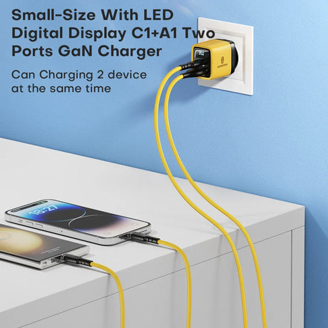 Compact yellow and black wall charger with LED display and two USB ports for charging multiple devices simultaneously.