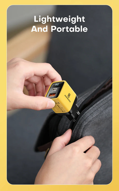 Compact yellow cube-shaped device with USB ports being plugged into a bag.