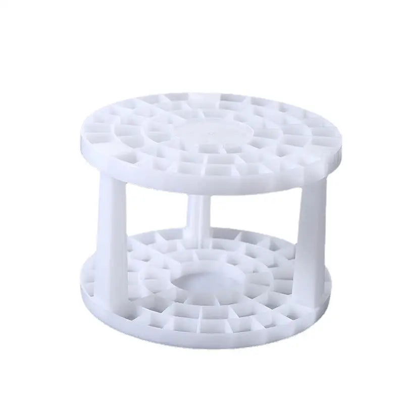 a white plastic cake stand with three tiered sections