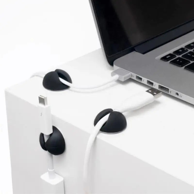 a laptop and earphones on a white table