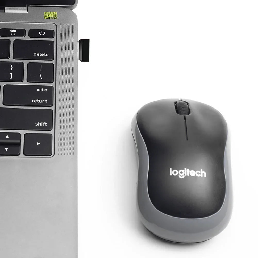 a computer mouse and a laptop on a white surface