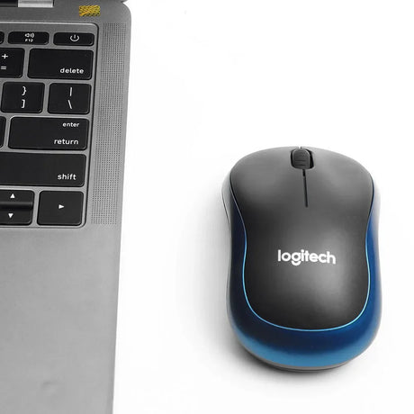a computer mouse and a laptop on a white surface