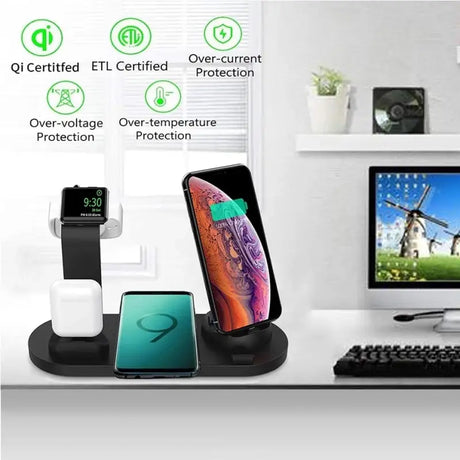 a computer, phone and other electronics on a desk