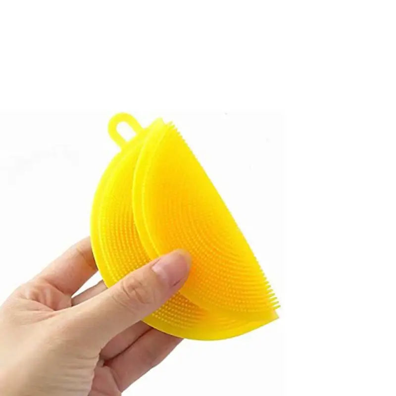 a hand holding a yellow plastic brush