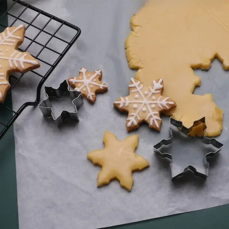 a cookie cutter and some cookies on a table