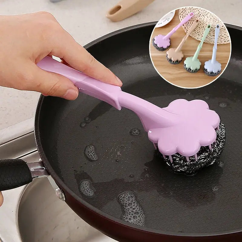 a person using a spat to stir a pan of food