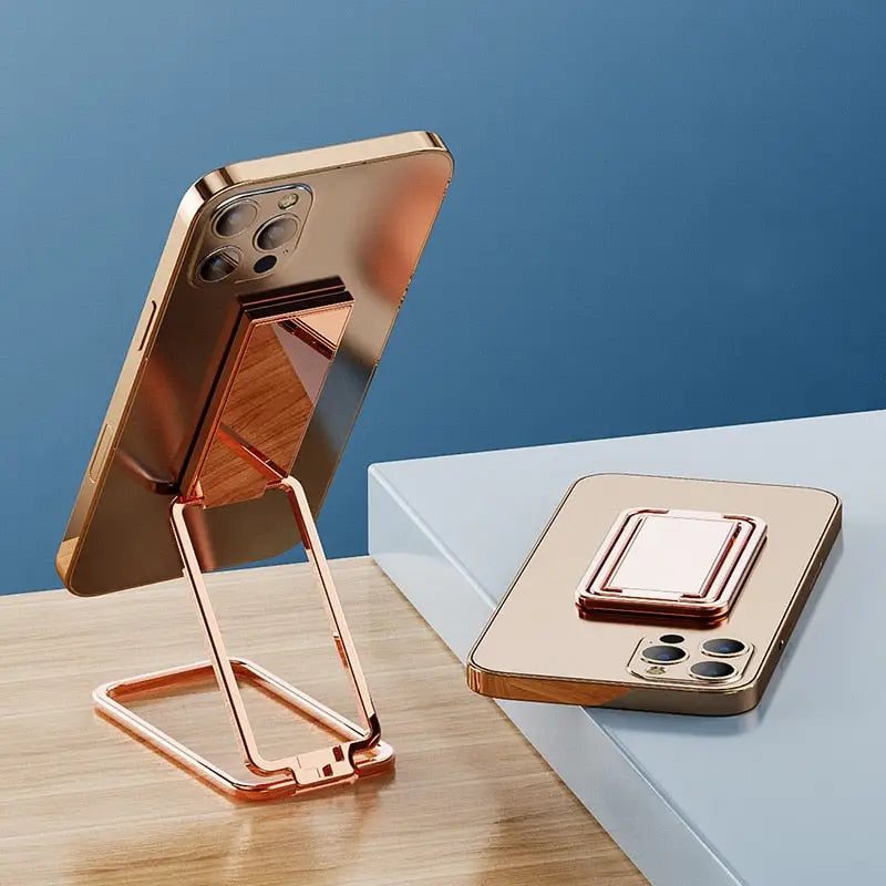 the copper iphone stand is on a table