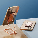 the copper iphone stand is on a table