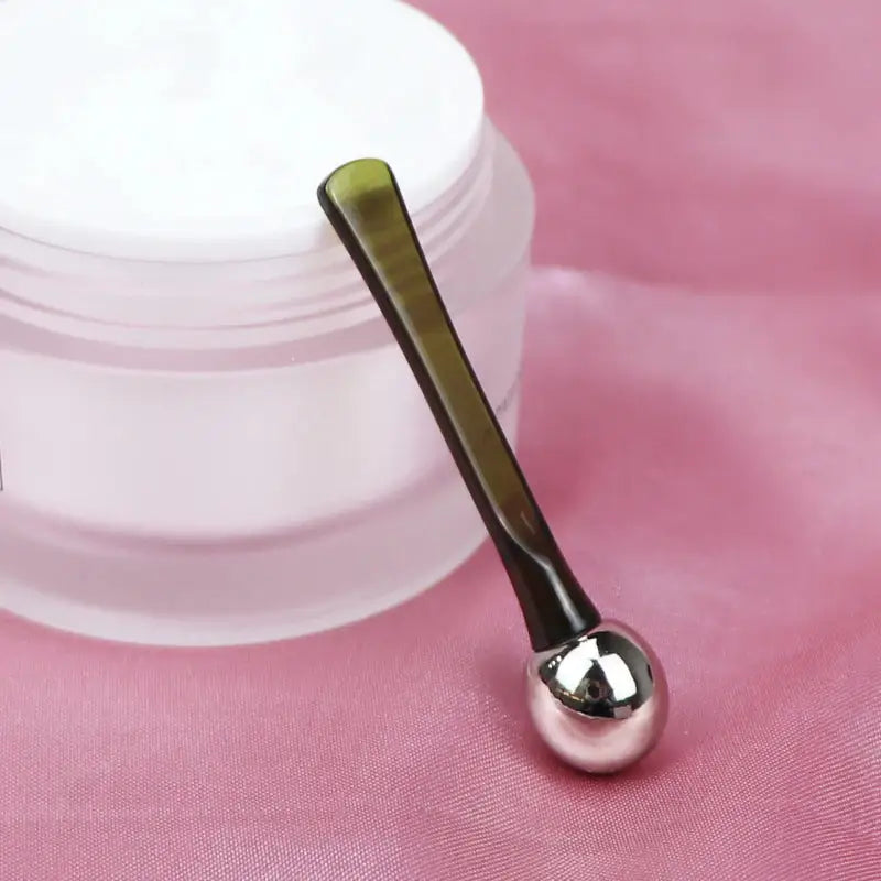 a spoon with a white container on top of it