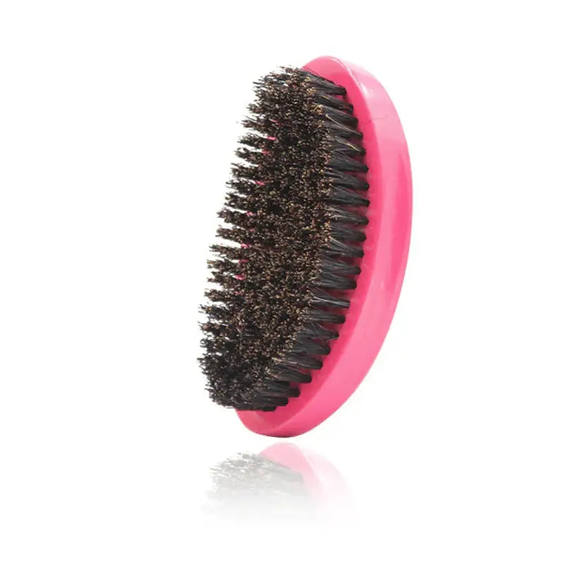 a pink brush with black bristles on it