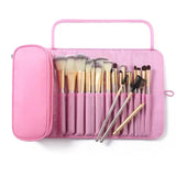a pink makeup brush case with a set of brushes