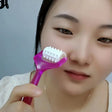 a woman brushing her teeth with a tooth brush