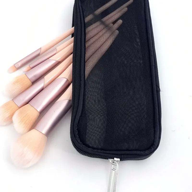 a close up of a bag with a bunch of makeup brushes in it