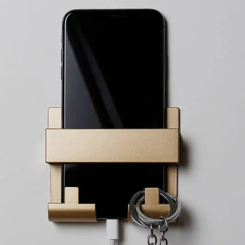 a phone and a key hanging on a wall