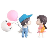 a couple of figuris with balloons
