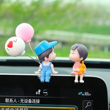 a couple sitting on top of a car dashboard