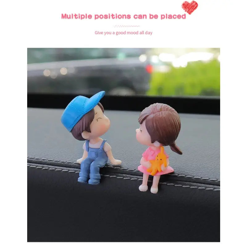 a couple sitting on the dashboard of a car