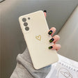 Cream-colored smartphone case with a gold heart design.