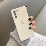 Cream-colored smartphone case with a gold heart design.