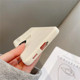 A creamy white silicone phone case with a small heart outline and a ribbed detail.