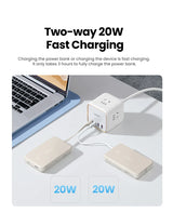 Cube-shaped power adapter with multiple USB ports for fast charging devices.