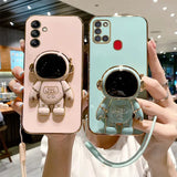 a woman holding two iphone cases with a small astronaut