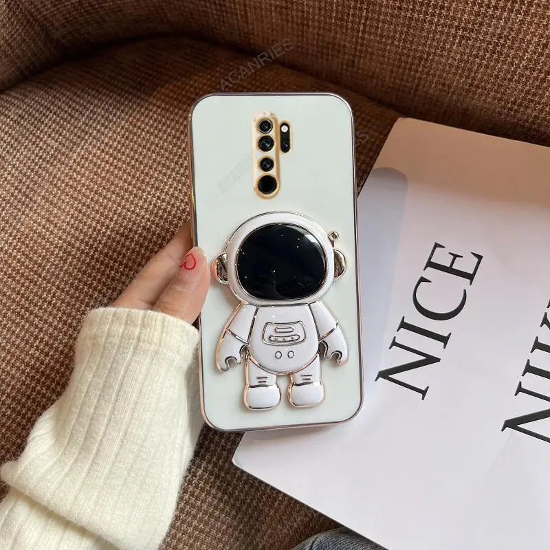 a white phone case with a small astronaut on it