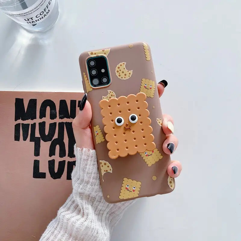 a woman holding a phone case with a bear design