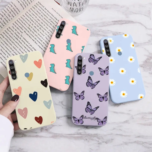 a woman holding a phone case with butterflies and flowers