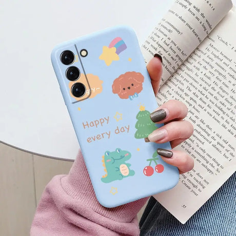 a woman holding a phone case with a cartoon design