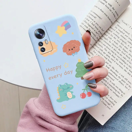 a woman holding a phone case with a cartoon design