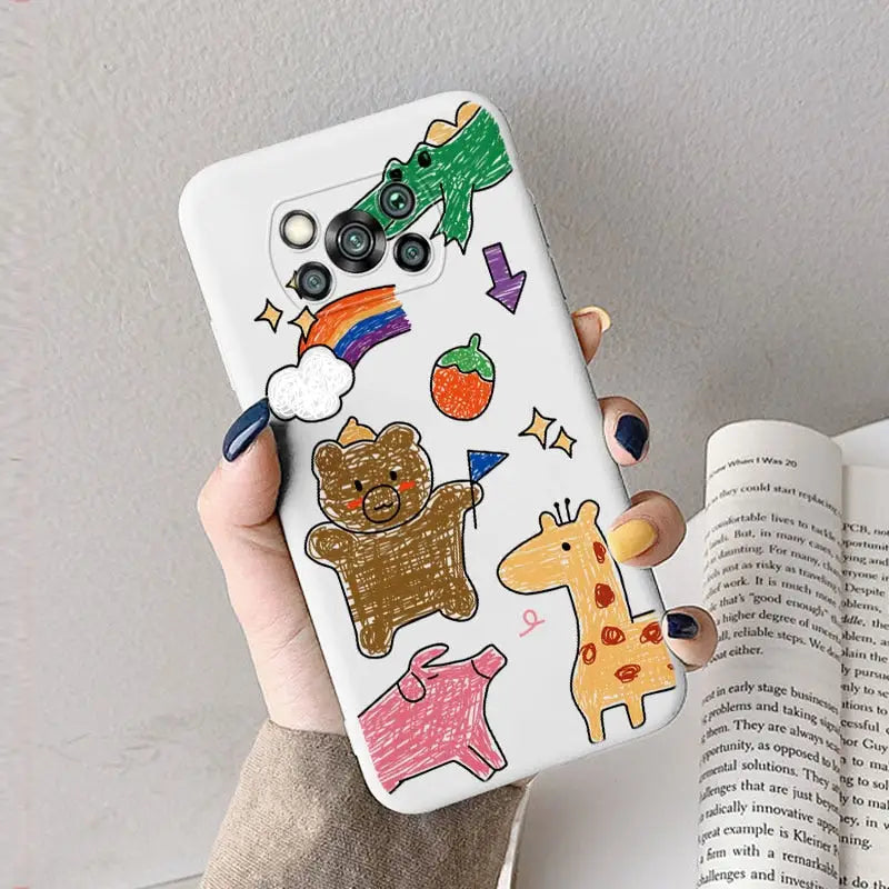 a hand holding a phone case with a cartoon bear and other animals